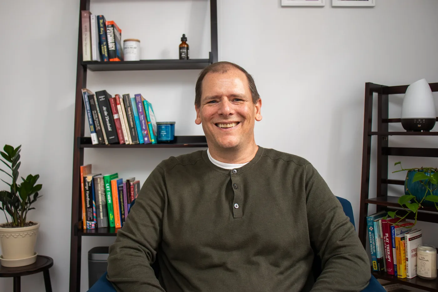 Stephen DiCarlo seated in his therapy office in Falls Church, Virginia.